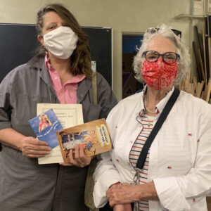 Two shoppers show some of the materials they just purchased.