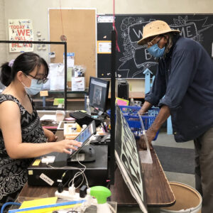 An employee at the register is ringing up a customer.