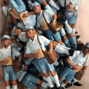 Plastic figurines of a postal worker.