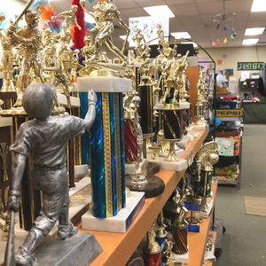 Trophies on a shelf with the register in the background.