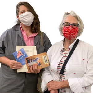 Two shoppers show some of the materials they just purchased.